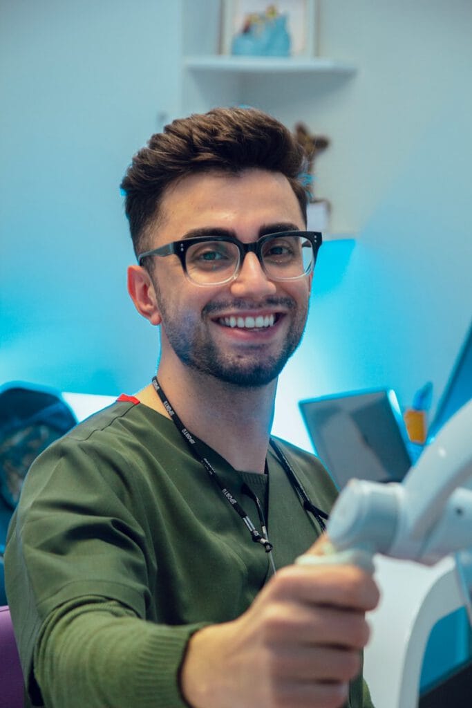 a man with glasses is playing a video game